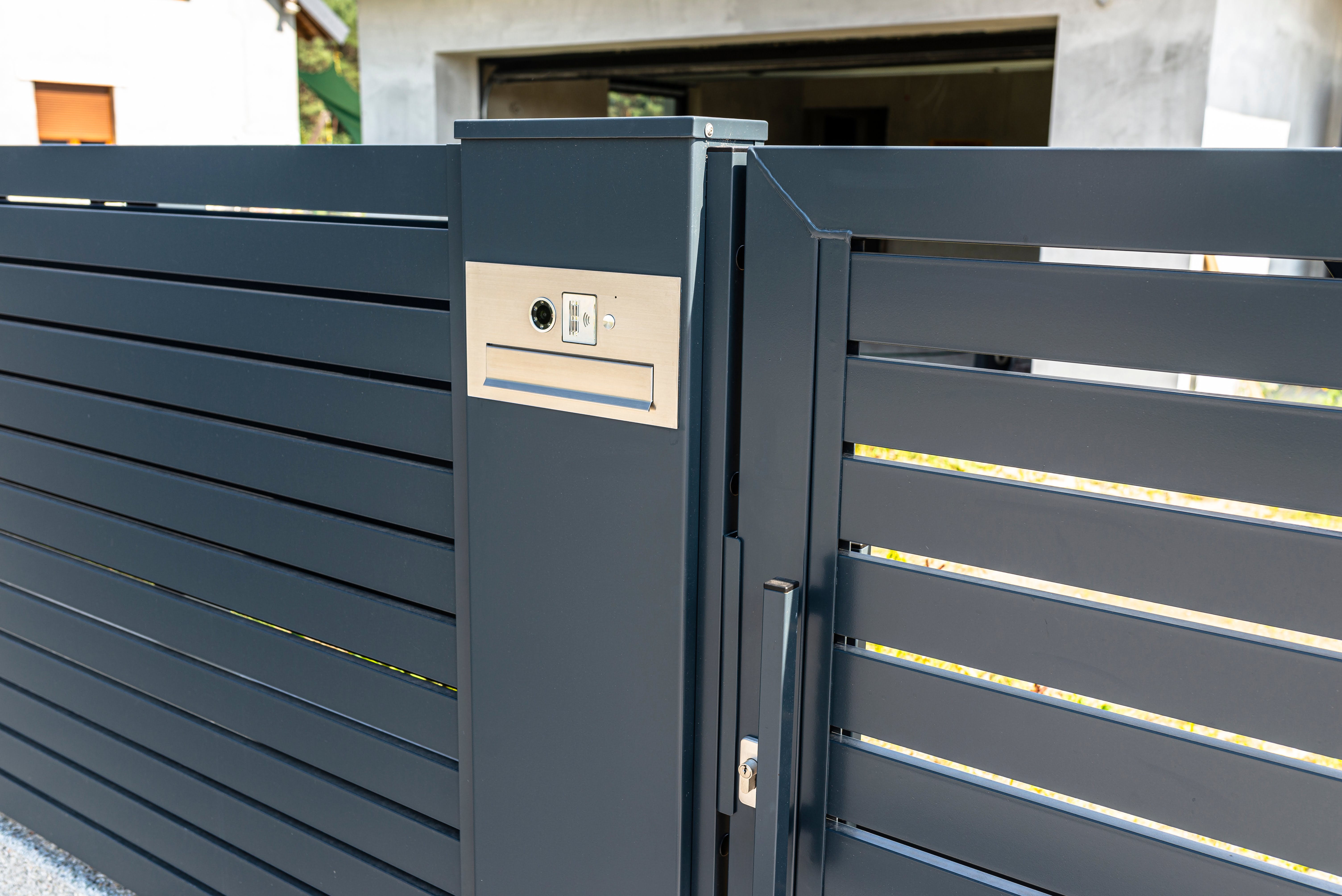 A modern videophone with a letterbox and a wireless card reader, mounted in panel fence in anthracit